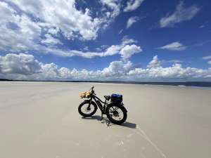 Fat tire eBike on a wide empty beach beneath a dramatic Florida sky